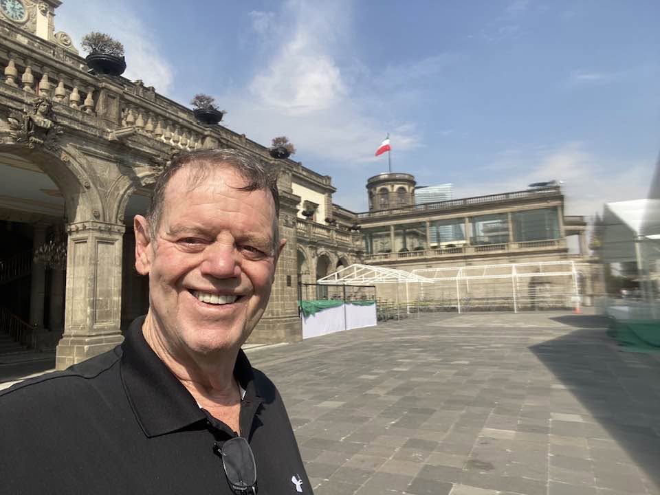John smiling in front of Chapultepec Castle in Mexico City