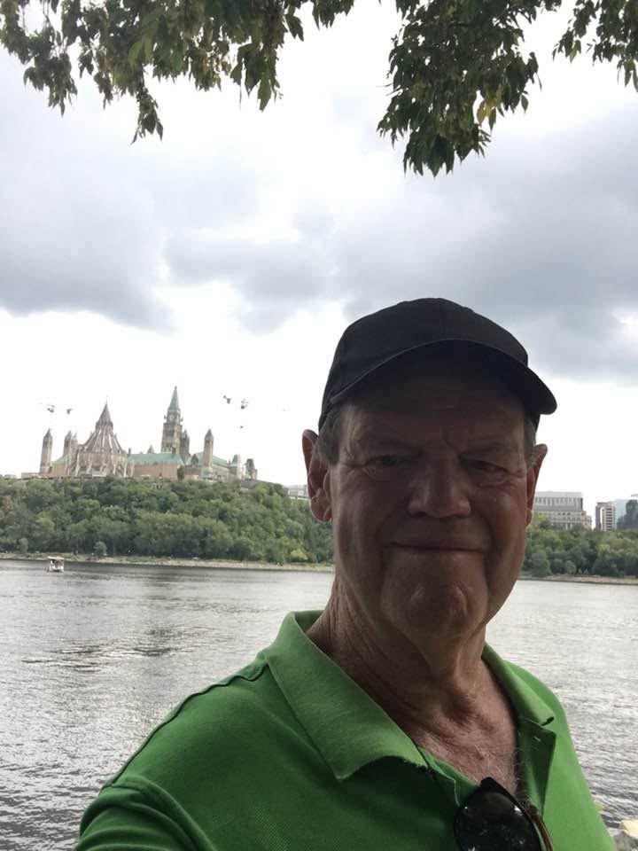John along the river in Ottawa, Canada, with Parliament Hill in the background
